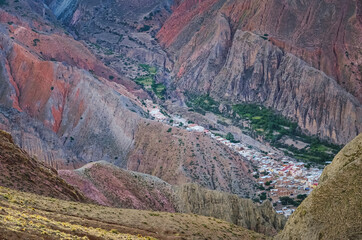 Stock photo of the Iruya village between colored hills and mountains valley. Salta, Argentina....