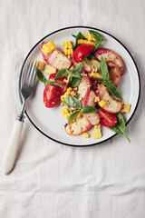 Salad with grilled peaches, corn,  tomatoes and basil.