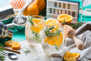 Hard seltzer cocktail with orange and zero waste bartenders accessories