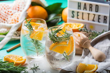 Hard seltzer cocktail with orange and zero waste bartenders accessories