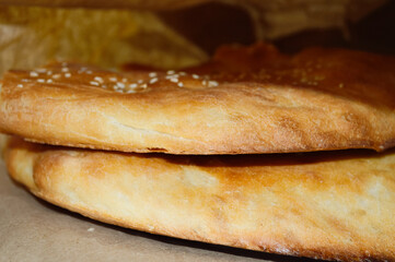 two hot tasty flatbreads in a paper bag - side view
