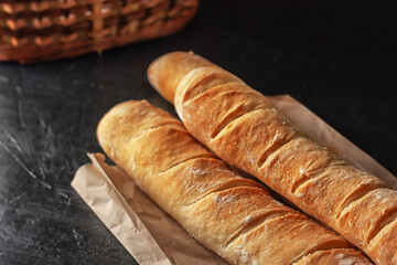 French baguettes on a table covered with cloth. Selective focus.