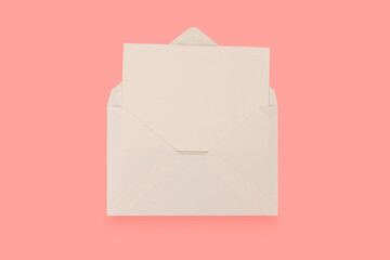 Simple small envelope with space for writing on a colourful pink background. close-up. Flat lay. Holiday and best wishes concept.