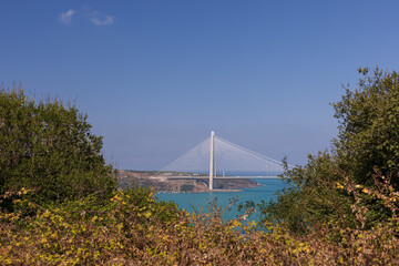 Fototapeta na wymiar Views of the Bosphorus and bridges in the city of Istanbul. Turquoise sea water and bright sun.