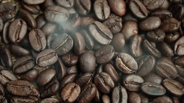 Roasted coffee beans, the smoke comes from the coffee beans. All elements will slowly move around the camera.