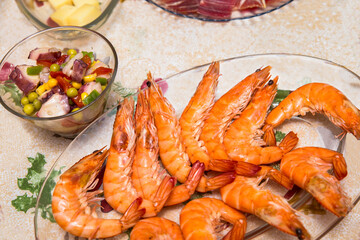 glass tray with boiled shrimps and bowl with octopus in vinaigrette