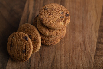 Delicious cookies with chocolate on a wooden board