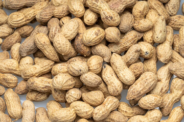 inshell peanuts close-up, organic peanuts, top view, selective focus. background image