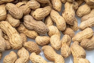 inshell peanuts close-up, organic peanuts, top view, selective focus. background image