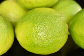 Group of green ripe lime, close-up, on a black background.