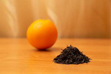 Orange, fruit with dried tea. On the golden background, orange table. Golden curtains. Vitamin C