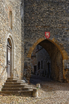 PEROUGES, FRANCE, February 23, 2021 : The church entrance. The town was restored and houses were saved in the beginning of 20th century and is now a popular tourist attraction.