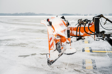  Plow snow preparing to clear snow from the runway.