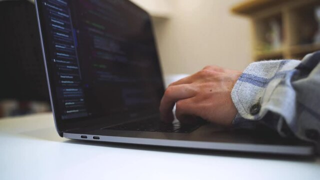 Code on the laptop screen, working environment in the office of programmers