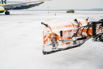  Plow snow preparing to clear snow from the runway.