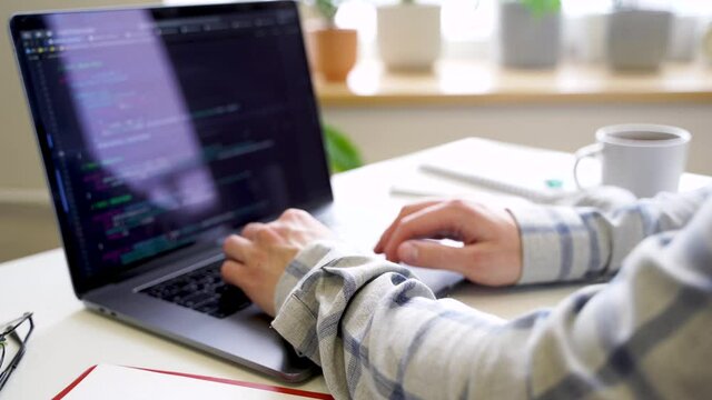 Code on the laptop screen, working environment in the office of programmers