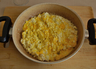 scrambled egg with feta cheese, served with a small frying pan.