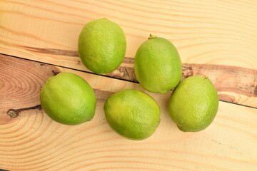Ripe tasty lime, close-up, on a painted wooden table.