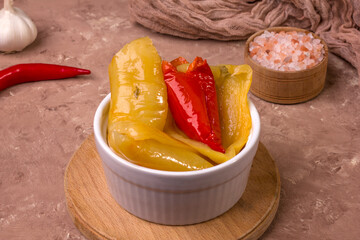 Fermented red and yellow bell peppers. Vegetarian food. Salted bell peppers. Pickled organic bell peppers. Homemade fermented foods. Food stocks.