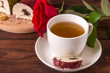 Cup with tea t oriental sweet chocolate halva with pistachios and pink powder