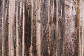 Old wooden boards in the form of a wall or wooden fence, authentic background from wooden boards