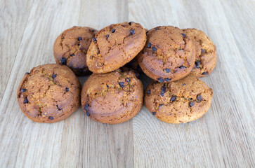 Cookies with brown chocolate on wooden background close up