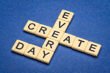 create every day - inspirational crossword in ivory letter tiles against textured handmade paper, creativity and personal development concept