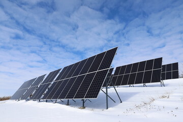 Solar panels Photovoltaic cells on a background of white and blue sky and snow. Alternative ecological solar energy.