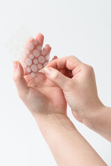 Round patches for acne and wrinkles on the hands on a white background. Acne and wrinkle patches...
