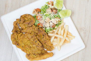 Homemade lunch with grilled meat and French fries