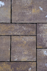 Mosaic of rough purple paving stones. Close up. Copy space. Vertical image.