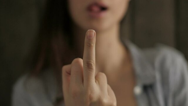 Girl showing middle finger in camera
