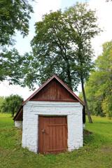 Obraz premium small cosy white brick warehouse in the forest