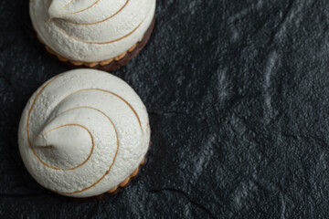 A line of delicious cupcakes on a dark background