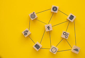 Network. Wooden blocks connected together on a yellow background. Teamwork concept