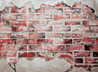 A fragment of the wall from which the paint peeled off and the brickwork appeared