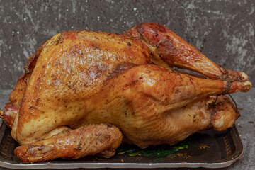 Homemade roast turkey, lemon close-up on a slate board on the table. Horizontal top view from above