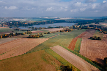 View of autumn forest and farmlands fields
