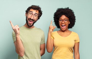 multiracial couple of friends feeling like a happy and excited genius after realizing an idea,...