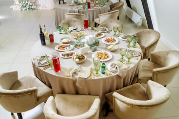 Beautiful served tables, wedding event. Lots of food and drinks.