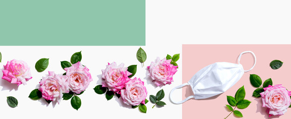 Face mask with pink roses overhead view - flat lay