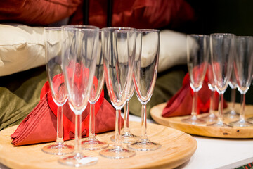 Rows of shiny empty high glasses with reflections in restaurant. Catering concept.Set of blank empty wine glasses displayed in rows. Preparation for the holiday.selective focus