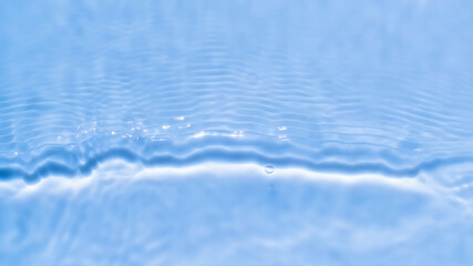 Cool blue texture of light-shadow pattern of sunlight reflection from rippled water surface. Beautiful natural pattern with 3D feeling. Clear ozonized mineral water.