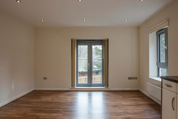 Fototapeta premium View of an empty living room area in a modern apartment with wooden flooring