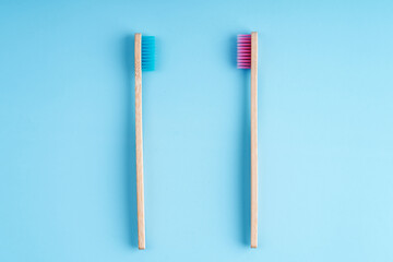 A pair of eco-friendly bamboo toothbrushes. Global environmental trends. Toothbrushes of different genders