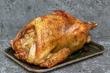 Homemade roast turkey, lemon close-up on a slate board on the table. Horizontal top view from above