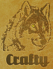 Wolf's head engraved on leather with the legend crafty