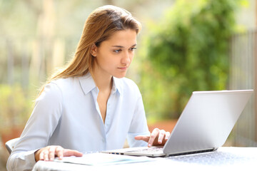 Entrepreneur working with laptop in a garden at home