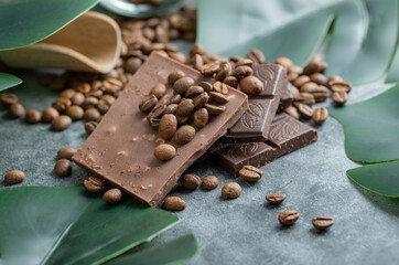 Chocolate bars with chocolate chips on a gray background