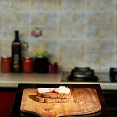 a slice of bacon filmed on a kitchen background on a wooden plank